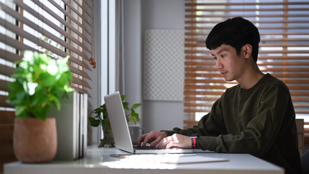 Man researching online information using people search databases.