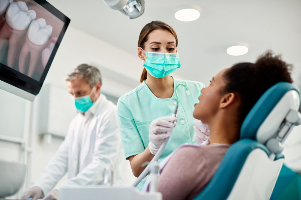 Nurse preparing dental patient for procedure, demonstrating infection control protocols