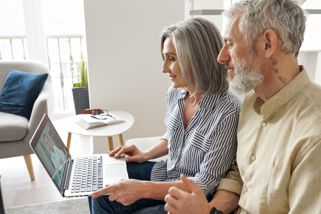 Senior couple getting online telemedicine call consultation with virtual doctor.