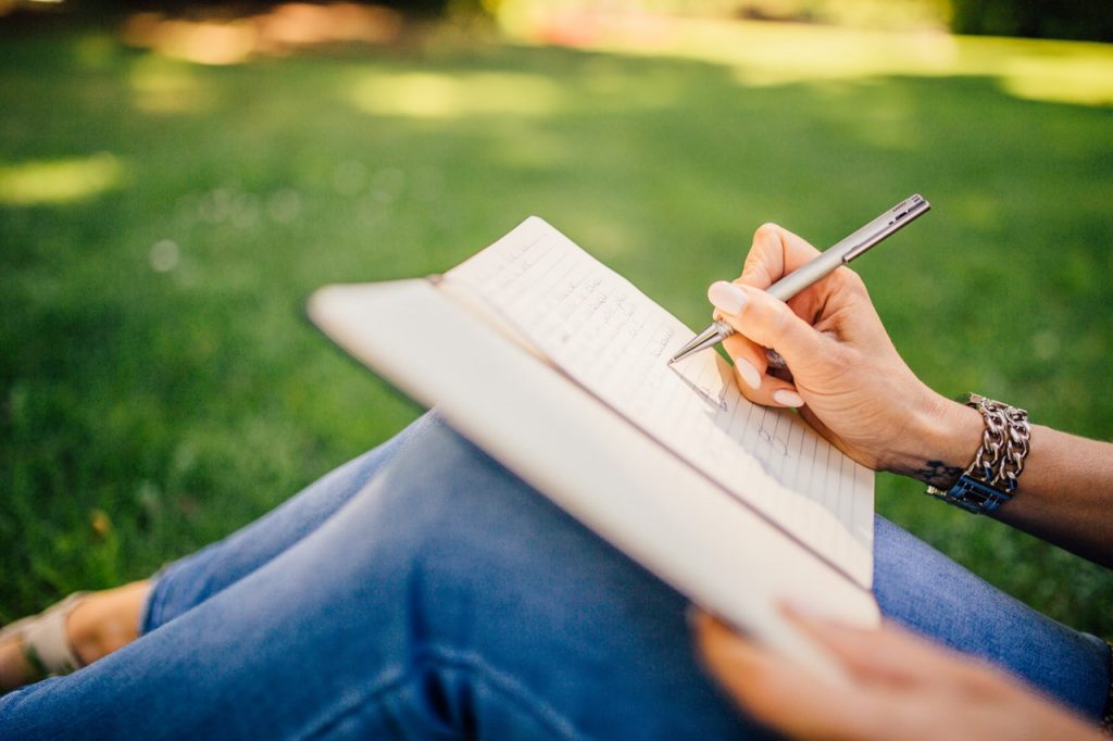 a person writing on a piece of paper