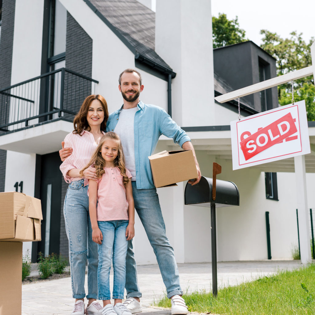 a family standing outside a house