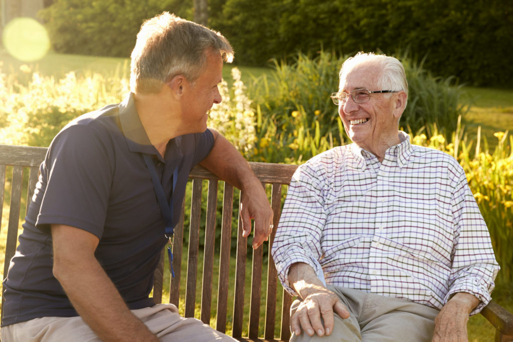 a couple of men sitting on a bench