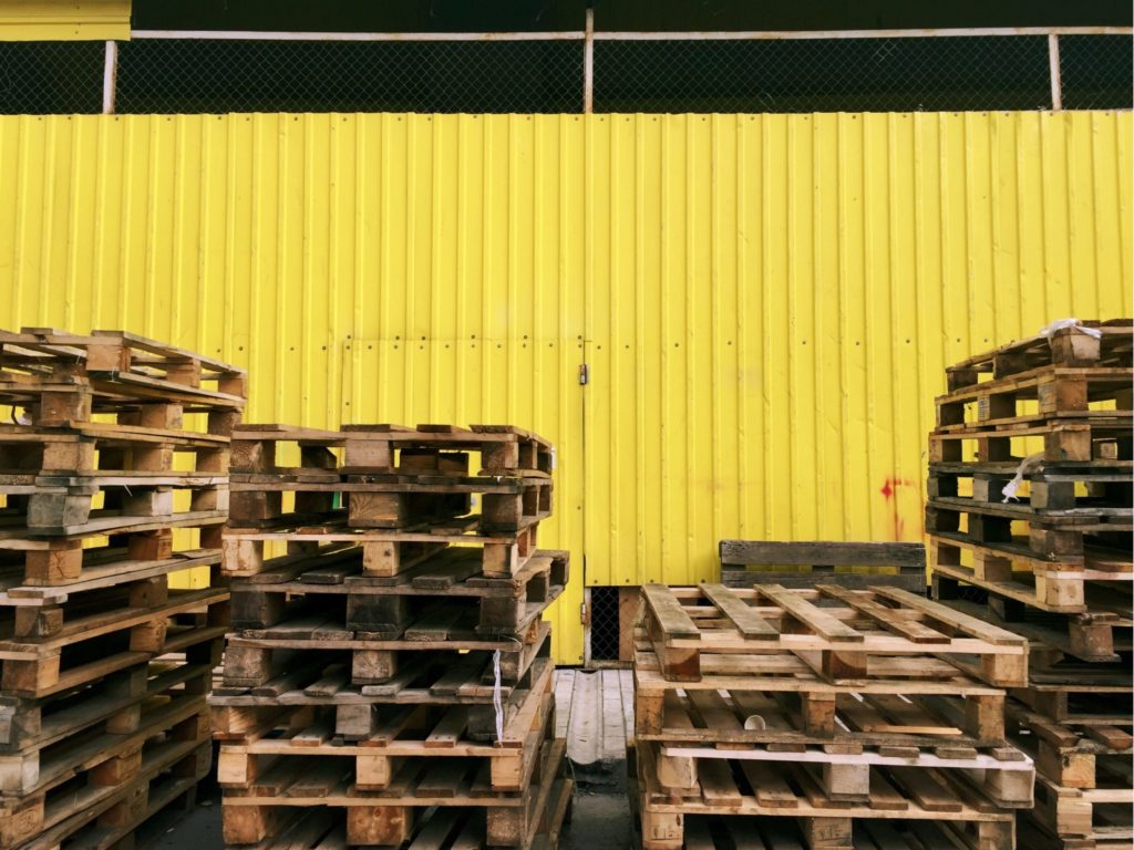 Pallets on yellow background