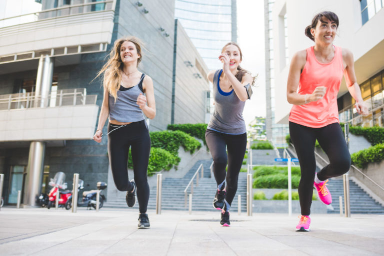 Three sportive women running