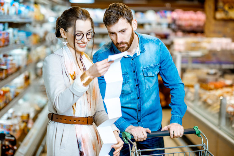 Couple with long shopping list in the supermarket