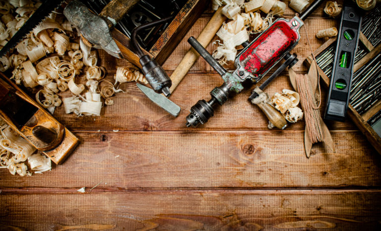 Various working tools on wood on the table.